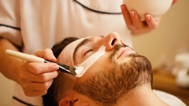 A facial mask being brushed on