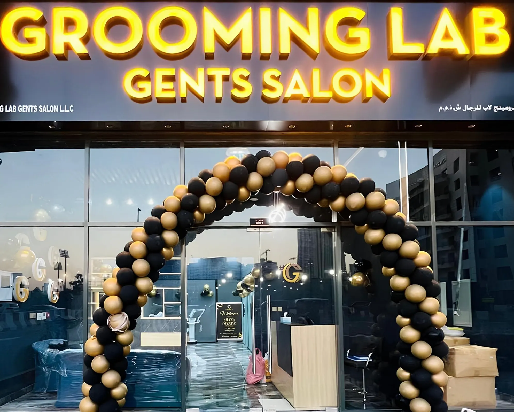 The lit Grooming Lab Gents Salon sign above the shopfront in Al Jaddaf, Dubai